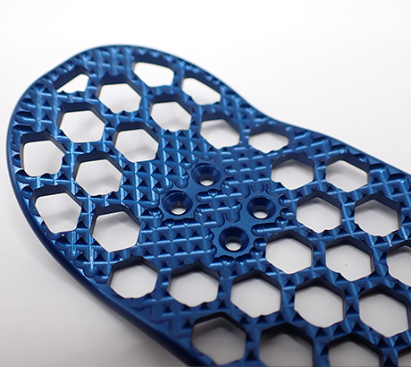 Metal fingerboard with machined grip in blue.
